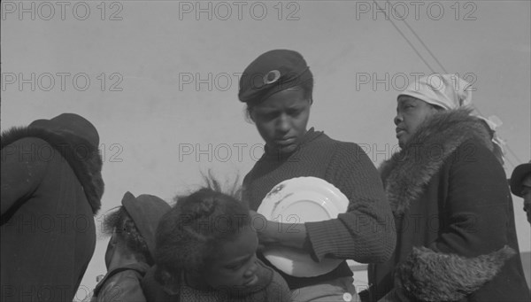 Possibly: Negroes in the lineup for food at mealtime in the camp..., Forrest City, Arkansas, 1937. Creator: Walker Evans.