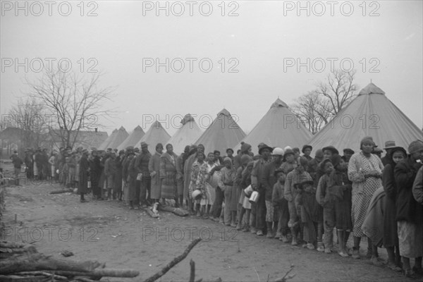 Possibly: Negroes in the lineup for food at mealtime in the camp..., Forrest City, Arkansas, 1937. Creator: Walker Evans.