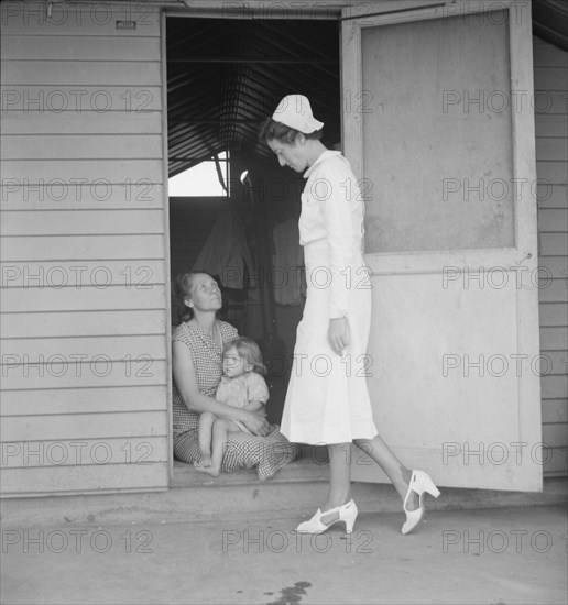 Resident nurse come to visit family, FSA camp, Farmersville, Tulare County, 1939. Creator: Dorothea Lange.