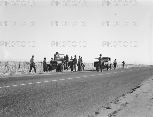 Migratory agricultural workers - cotton hoers, near Los Banos, California, 1939. Creator: Dorothea Lange.