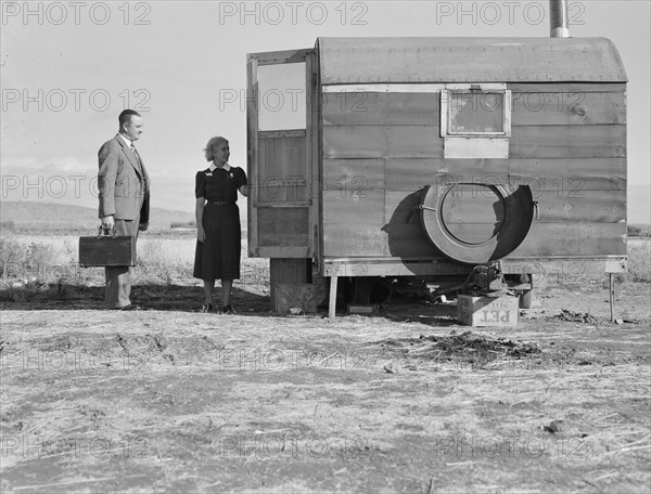 The camp nurse introduces doctor to mother of sick baby, Merrill, Klamath County, Oregon, 1939. Creator: Dorothea Lange.