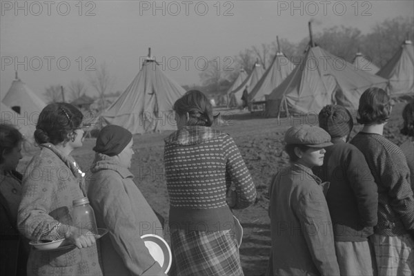 Possibly: Refugees lined up at meal time in the camp for white flood...Forest City, Arkansas, 1937. Creator: Walker Evans.