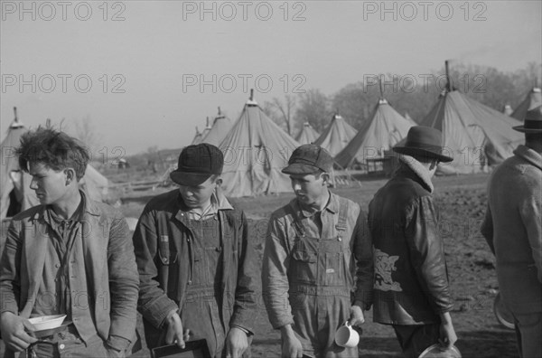 Possibly: Refugees lined up at meal time in the camp for white flood...Forest City, Arkansas, 1937. Creator: Walker Evans.