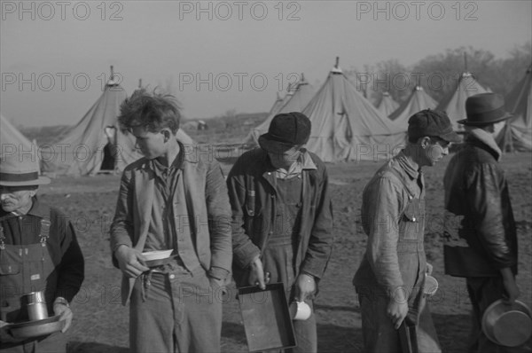 Possibly: Refugees lined up at meal time in the camp for white flood...Forest City, Arkansas, 1937. Creator: Walker Evans.