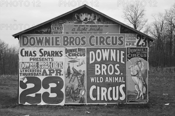 Posters covering a building near Lynchburg to advertise a Downie Bros. circus, 1936. Creator: Walker Evans.