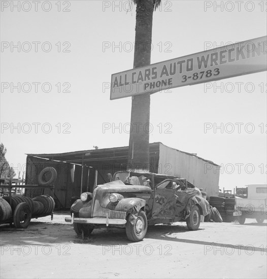 Used car lots and auto wrecking establishments, U.S. 99,  Near Tulare, California, 1939. Creator: Dorothea Lange.