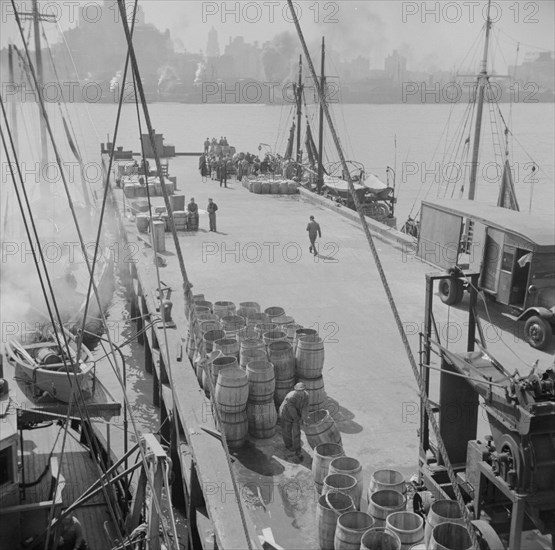 A scene at the Fulton fish market showing the dock where New England fishing, New York, 1943. Creator: Gordon Parks.