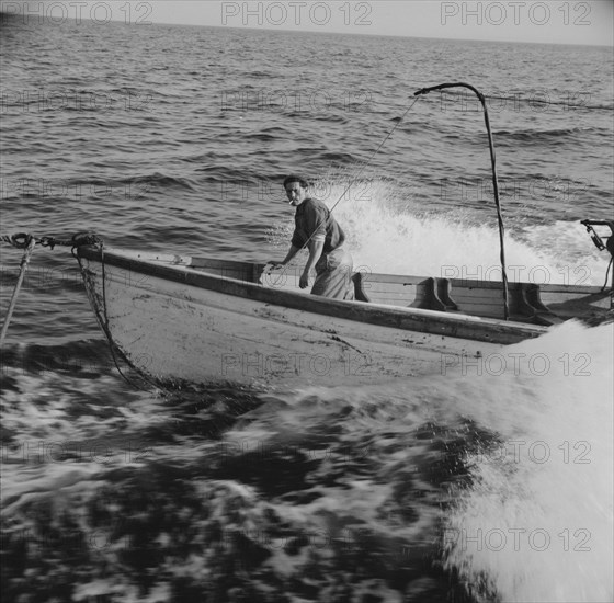 Giacomo Frusteri in the prow of the seining boat as it races to..., Gloucester, Massachusetts, 1943. Creator: Gordon Parks.