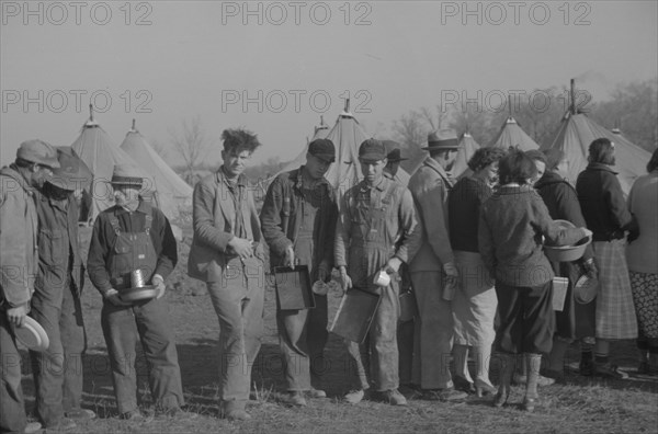 Possibly: Negroes in the lineup for food at the flood refugee camp, Forrest City, Arkansas, 1937. Creator: Walker Evans.