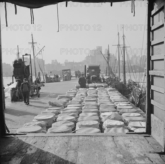 Barrels of fish on the docks at Fulton fish market ready to be shipped to..., New York, 1943. Creator: Gordon Parks.