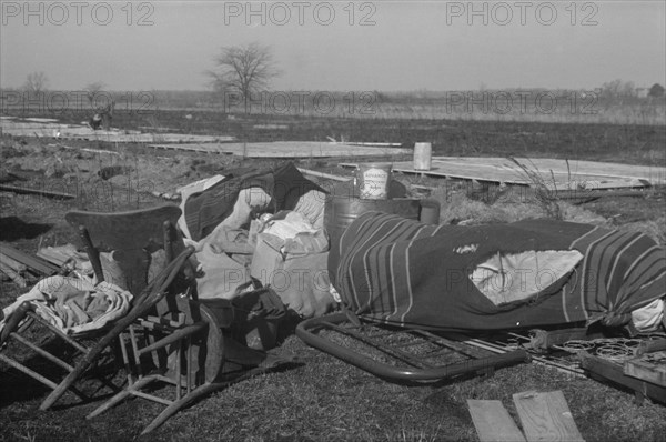 Possibly: Setting up a tent in the camp for white flood refugees, Forrest City, Arkansas, 1937. Creator: Walker Evans.