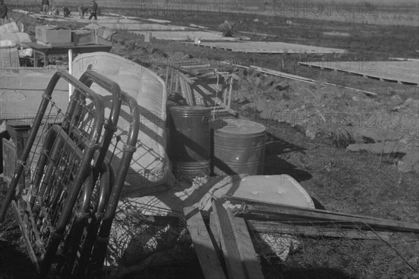 Possibly: Setting up a tent in the camp for white flood refugees, Forrest City, Arkansas, 1937. Creator: Walker Evans.