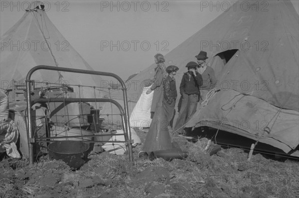 Possibly: Setting up a tent in the camp for white flood refugees, Forrest City, Arkansas, 1937. Creator: Walker Evans.