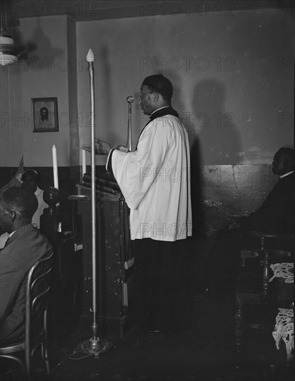 Reverend Vondell Gassaway, pastor of the St. Martin's Spiritual Church..., Washington, D.C., 1942. Creator: Gordon Parks.