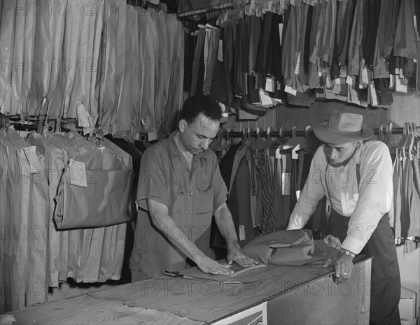 A tailor in Frank's cleaning and pressing establishment altering..., Washington, D.C., 1942. Creator: Gordon Parks.