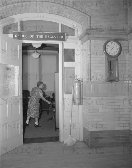 Charwoman cleaning after regular working hours at the Office...Treasury, Washington, D.C., 1942. Creator: Gordon Parks.