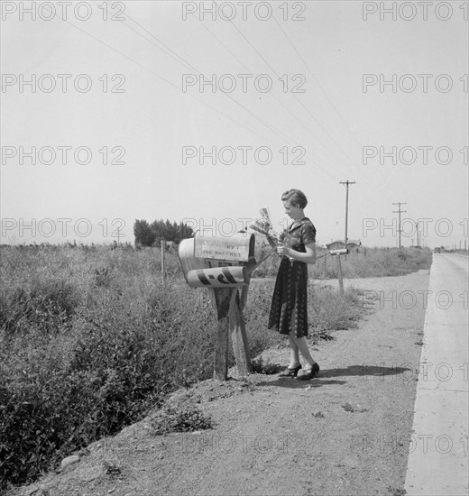 Mrs. Bouchey gets the morning mail, Washington, Yakima Valley, near Toppenish, 1939. Creator: Dorothea Lange.