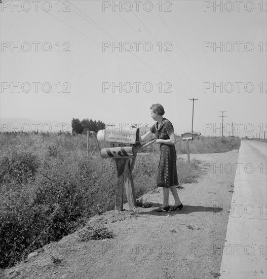 Mrs. Bouchey gets the morning mail, Washington, Yakima Valley, near Toppenish, 1939. Creator: Dorothea Lange.