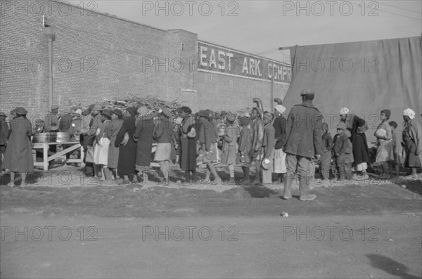 Possibly: Negroes at mealtime in the flood refugee camp, Forrest City, Arkansas, 1937. Creator: Walker Evans.