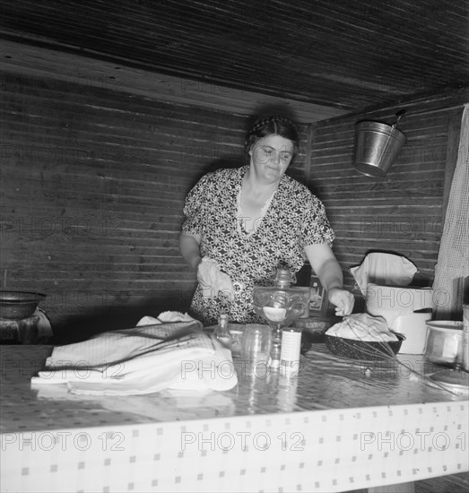 Tobacco sharecropper's wife cleaning up table after washing..., Person County, North Carolina, 1939. Creator: Dorothea Lange.