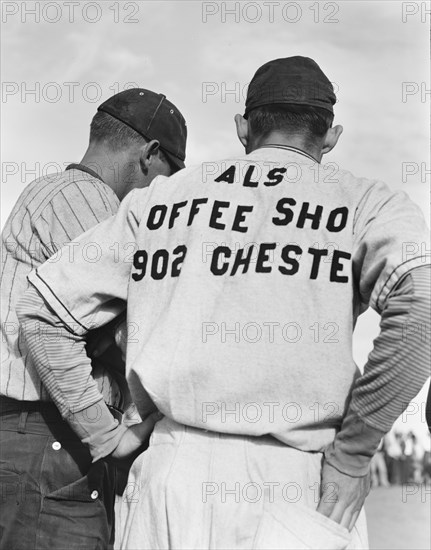 Watching ball game, Shafter migrant camp, California, 1938. Creator: Dorothea Lange.