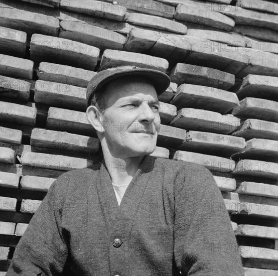 New England fisherman resting at the New York docks after unloading his cargo of fish, 1943. Creator: Gordon Parks.