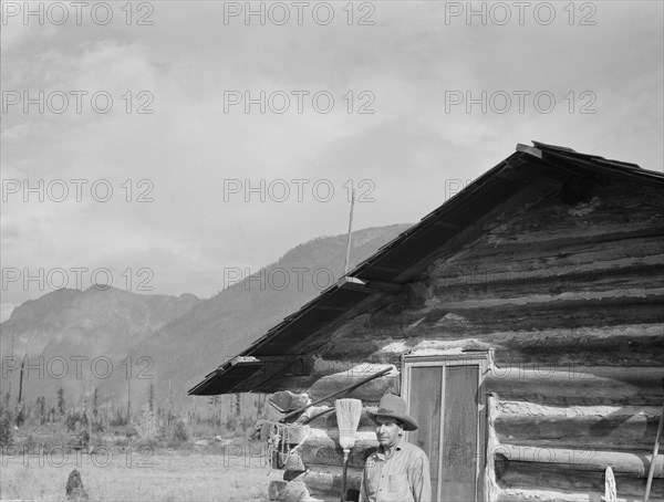 The mother, father, and hardworking fifteen-year-old son in yard..., Boundary County, Idaho, 1939. Creator: Dorothea Lange.