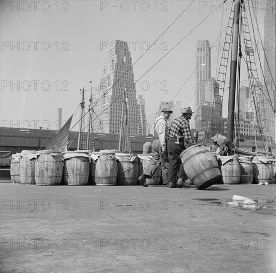 Barrels of fish on the docks at Fulton fish market ready to be shipped to retailers, New York, 1943. Creator: Gordon Parks.