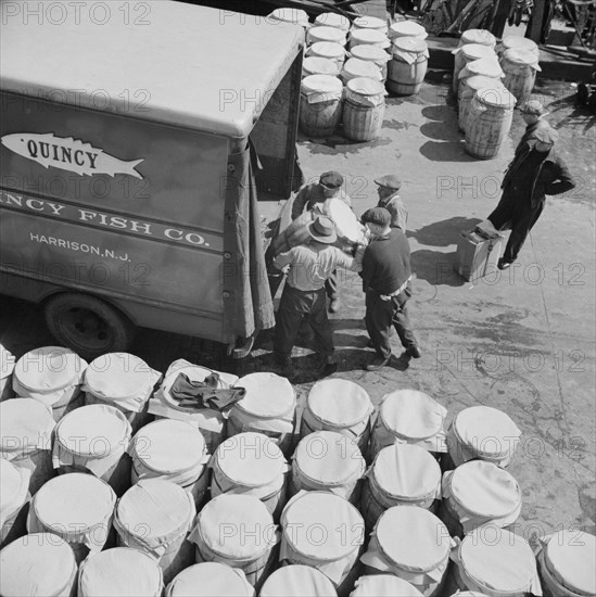 Barrels of fish on the docks at Fulton fish market ready to be shipped to retailers, New York, 1943. Creator: Gordon Parks.