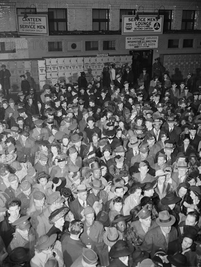 Crowds of soldiers, sailors, and civilians waiting to board trains at..., Washington, D.C., 1942. Creator: Gordon Parks.