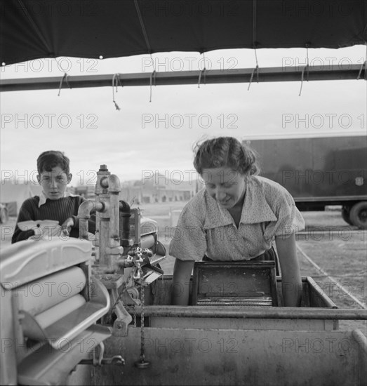 Portable laundry unit, shower unit beyond, FSA camp, Merrill, Oregon, 1939. Creator: Dorothea Lange.