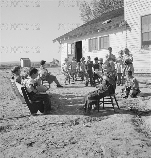 Entire enrollment of Lincoln Bench School. Teacher in center. Near Ontario, Oregon, Malheur County.