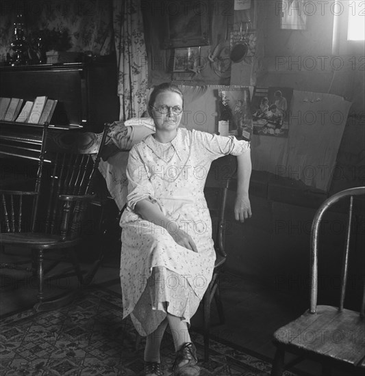 Mrs. Hull, in one room basement dugout home, late afternoon. Dead Ox Flat, Malheur County, Oregon.