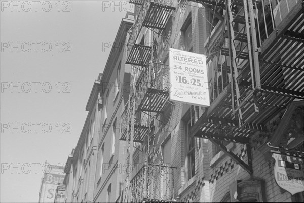 New York, New York. 61st Street between 1st and 3rd Avenues. A sign offering apartments for rent.