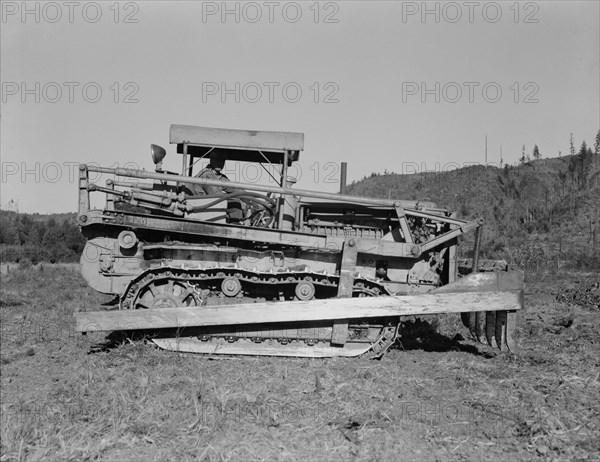 Western Washington, Lewis County. Caterpillar clearing land on cut-over western Washington farm.