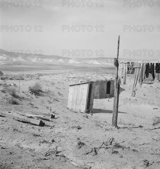 The Dazey place. Homedale district, Malheur County, Oregon. [Outside toilet and storm cellar].