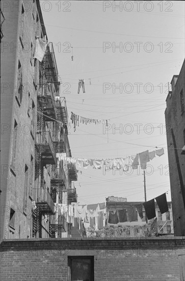 New York, New York. 61st Street between 1st and 3rd Avenues. Apartment houses from the rear.