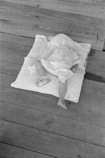 Squeakie asleep (Othel Lee Burroughs). Child of a Hale County, Alabama cotton sharecropper.