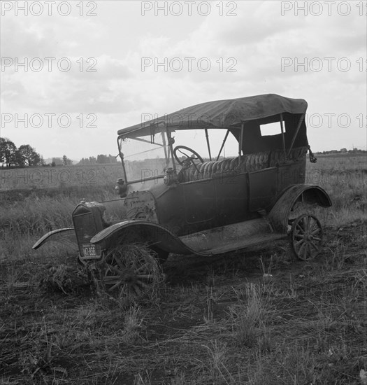 The end of the Model "T" abandoned in open field along Highway 99. North of Eugene, Oregon.