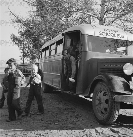 The children from Dead Ox Flat get off bus at school yard. Ontario, Malheur County, Oregon.