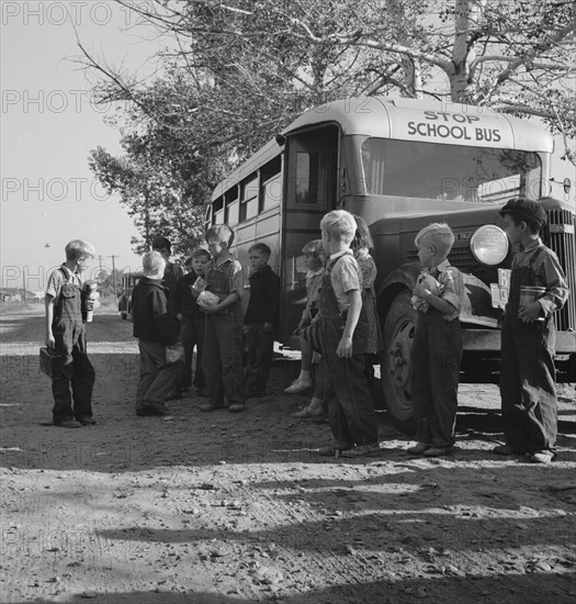 The children from Dead Ox Flat get off bus at school yard. Ontario, Malheur County, Oregon.