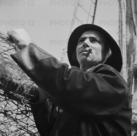 New York, New York. A New England fisherman preparing his boat to leave the New York docks.