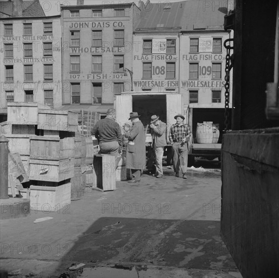 New York, New York. A buyer visits the wholesale district to purchase fish for his store.