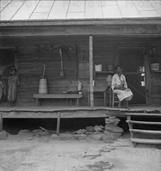 Porch of Negro tenant house, showing household equipment. Person County, North Carolina.