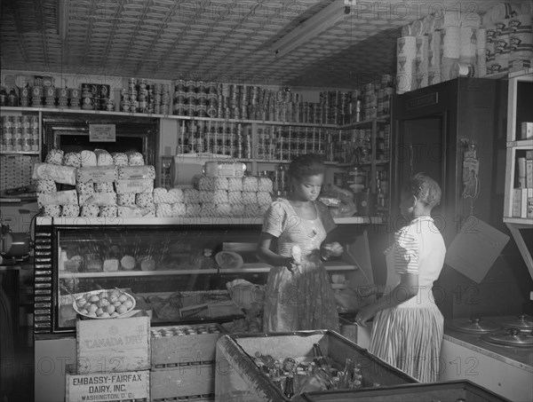 Washington, D.C. Mr. J. Benjamin's daughter waiting on a customer in her father's store.