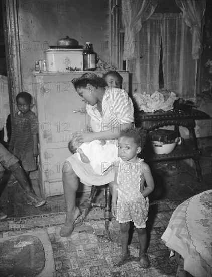 Washington, D.C. A mother getting the children ready for a neighborhood birthday party.