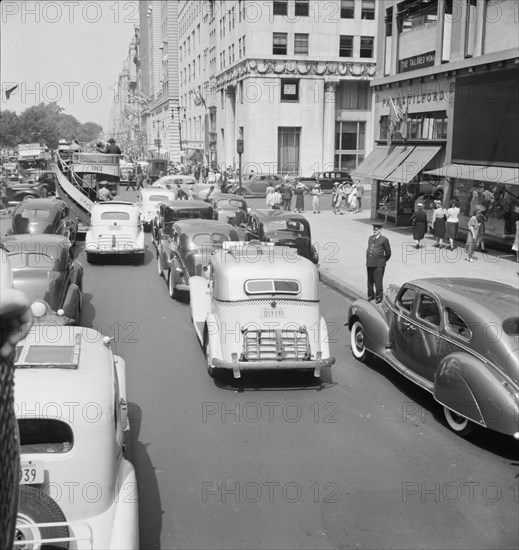 Traffic on Fifth Avenue approaching 57th Street on a summer afternoon. New York City.