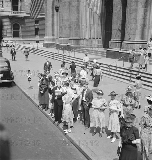 Fifth Avenue at Saint Patrick's Cathedral. Waiting for an uptown bus. New York City.