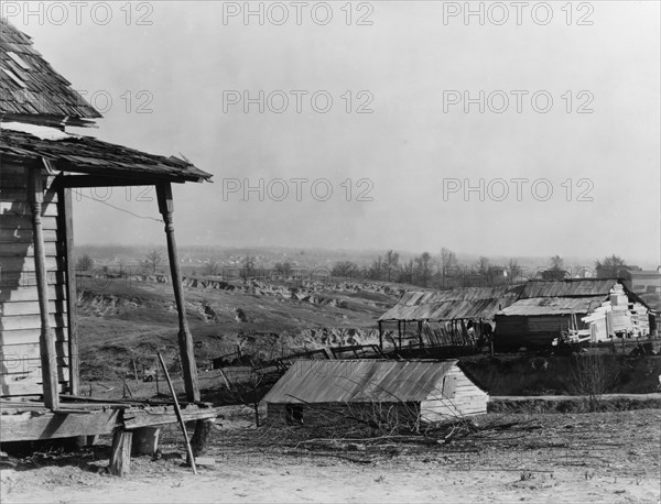 New outskirts of town, showing Negro houses and soil erosion. Tupelo, Mississippi.