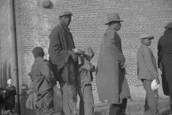 Negroes in the lineup for food at the flood refugee camp, Forrest City, Arkansas.